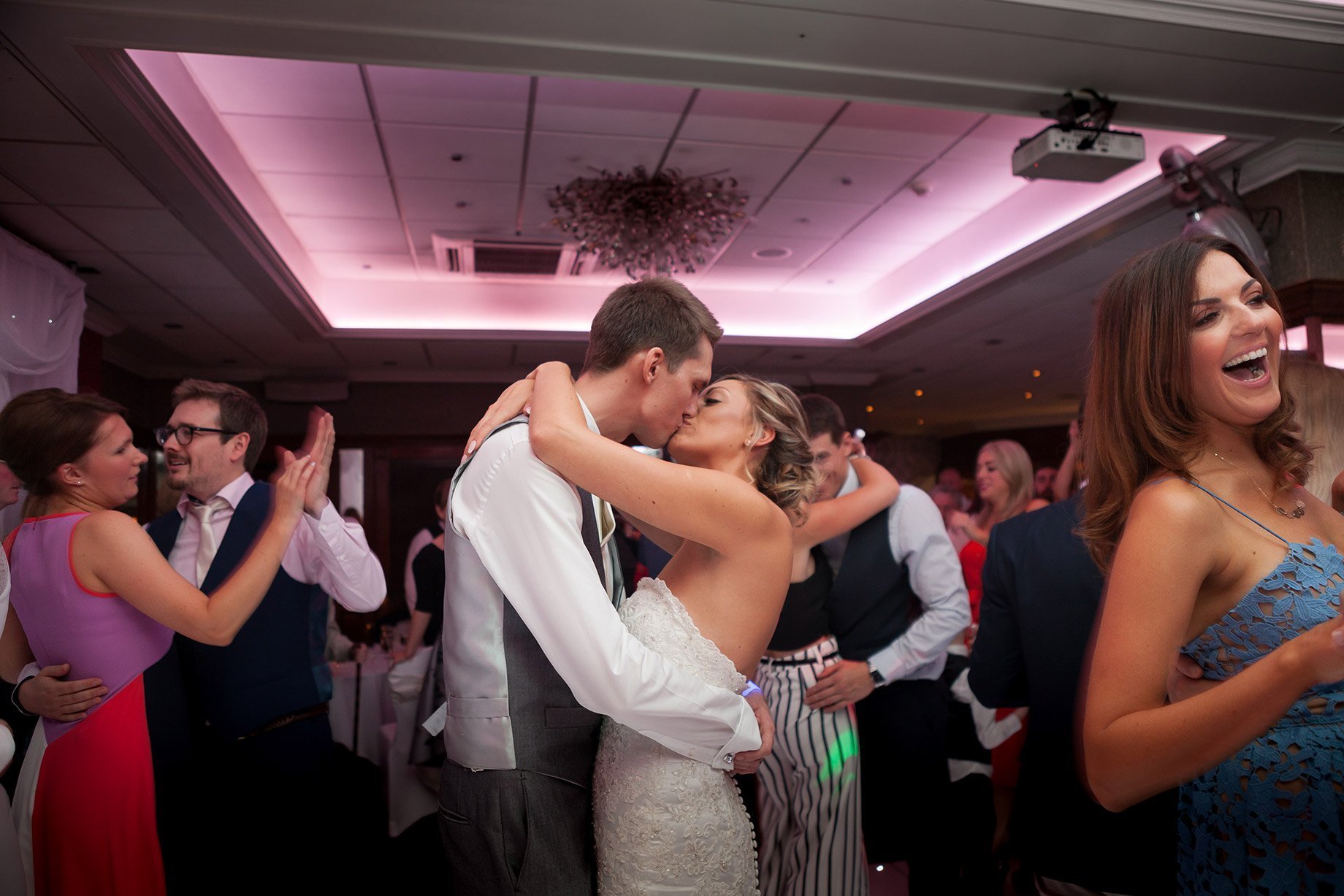Bride and groom kissing on dance floor  at Liverpool Sefton Park Sure Hotel